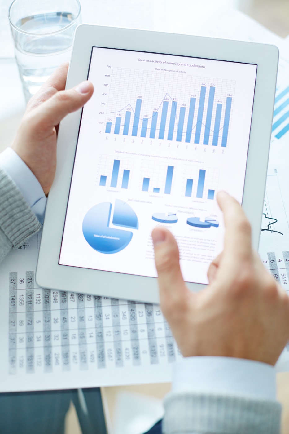Professional analyzing data graphs and business charts on a tablet