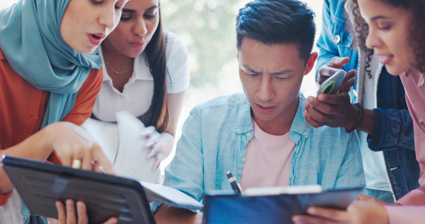 Professionals collaborating on a tablet and laptop