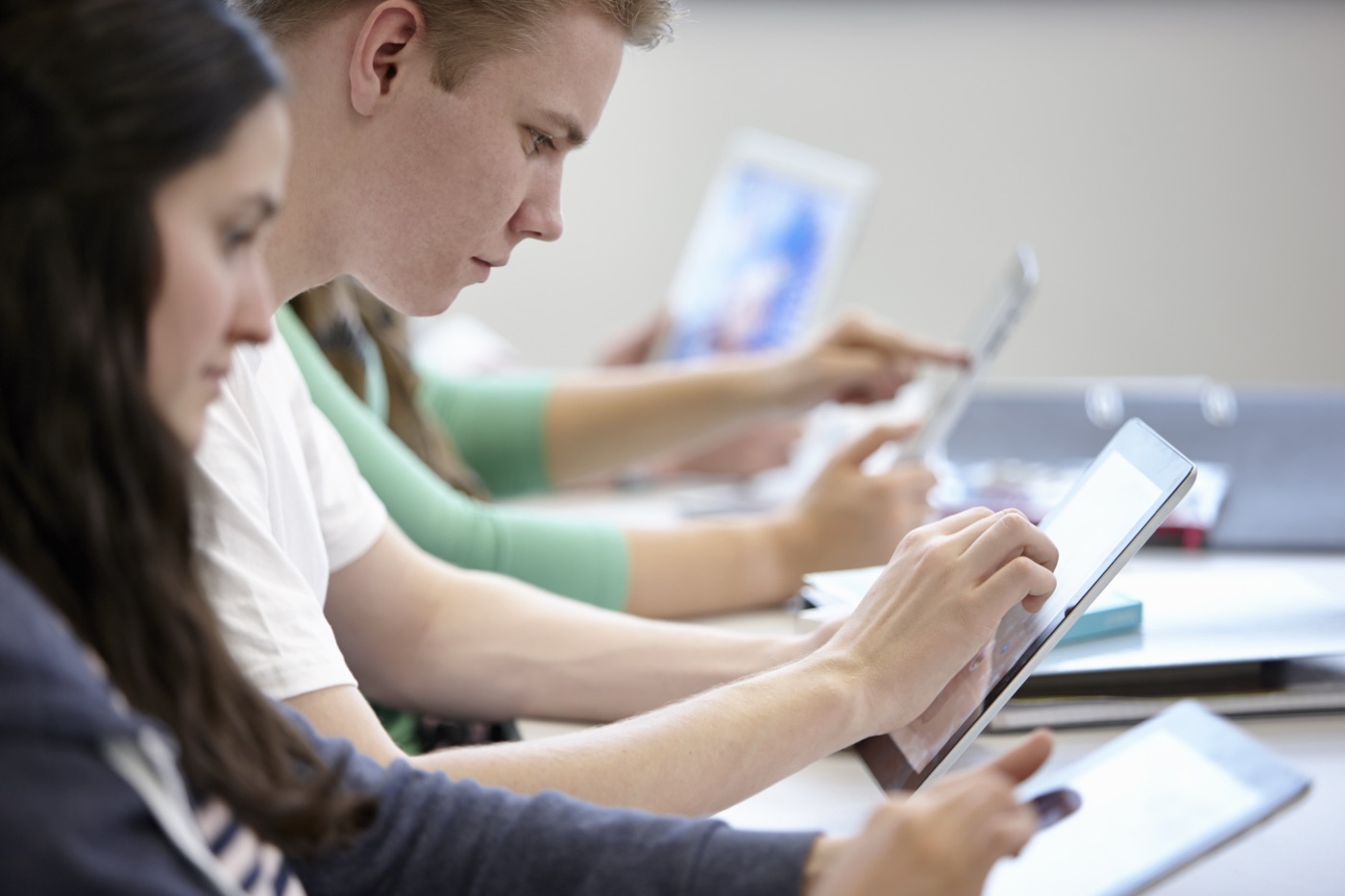 Students using tablets in a bright modern classroom