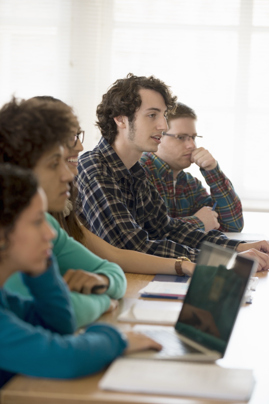 University students in a classroom setting with laptops